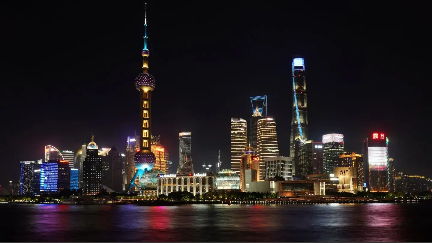 Shanghai Pudong skyline illuminated across the Huangpu River at night
